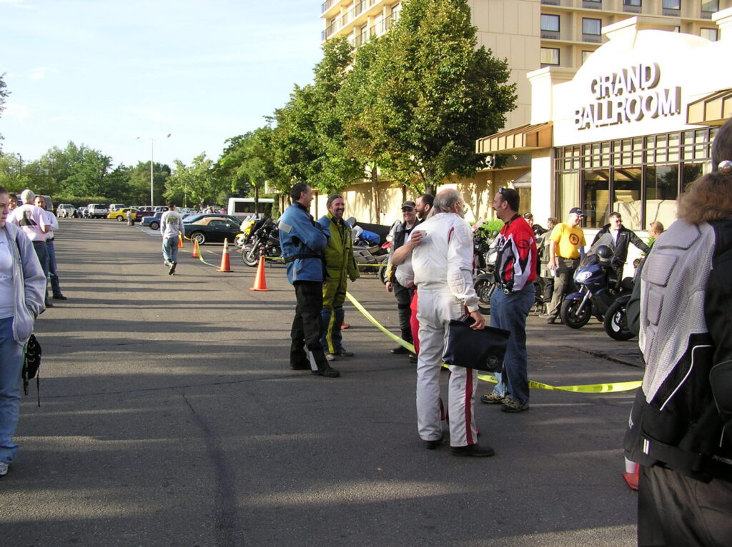 Riders and crew gather outside the Grand Ballroom as finishers arrive on the last morning of the rally.