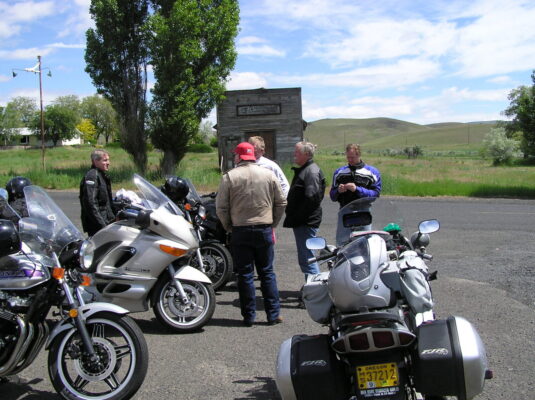 Riders gathered around the bikes
